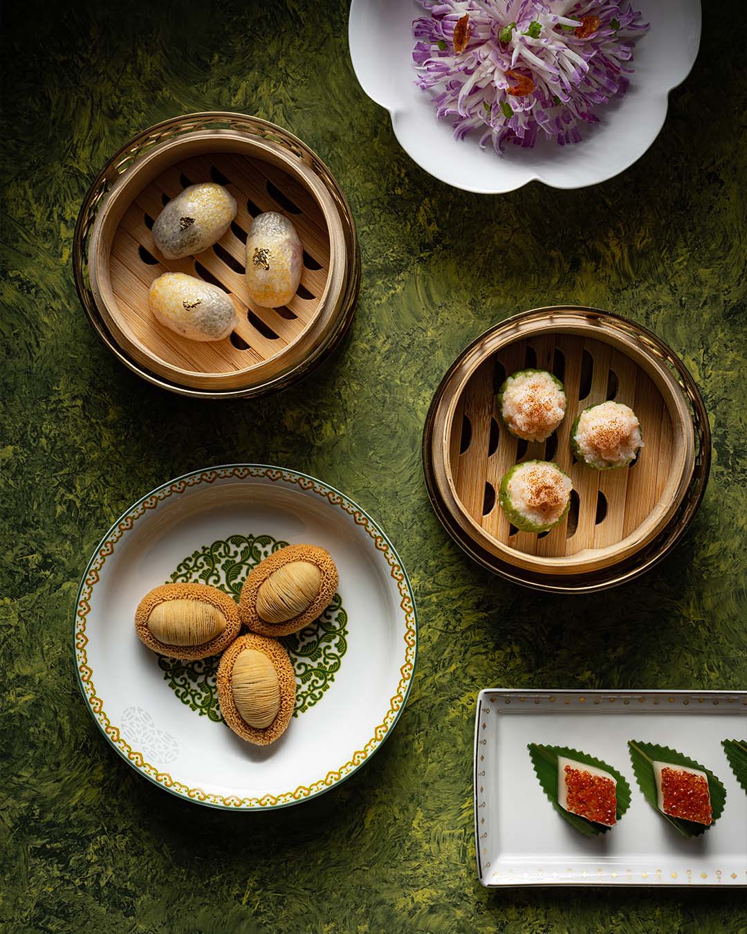Crystal skin dumplings with Min Dong yellow croaker, river shrimp siu mai with lava egg yolk, and braised abalone and pork belly puffs