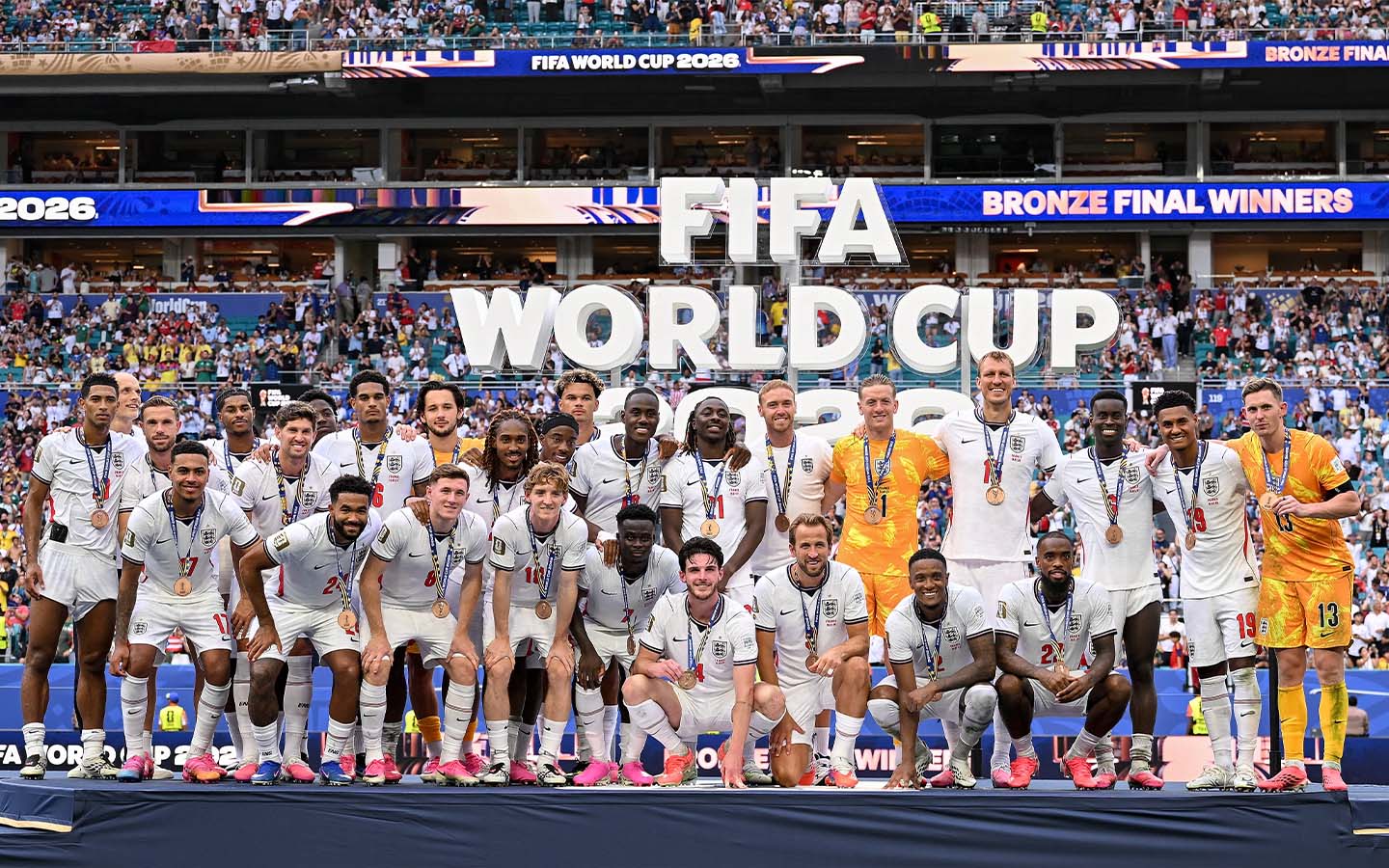 England players pose with their bronze medals at Miami Stadium after a 6-4 win over France - Saka hat-trick gives England bronze