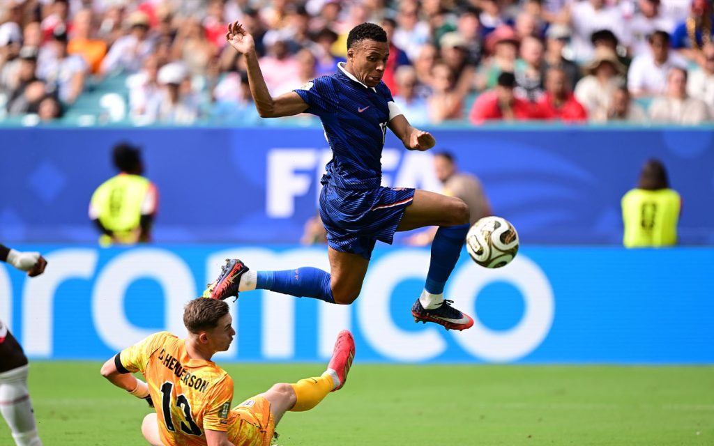 Kylian Mbappe skips past England goalkeeper Dean Henderson during France's 6-4 defeat at Miami Stadium