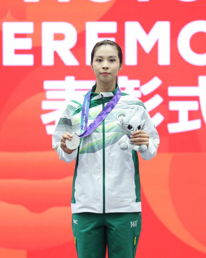 Sou Cho Man poses with her silver medal after the women's changquan final in wushu