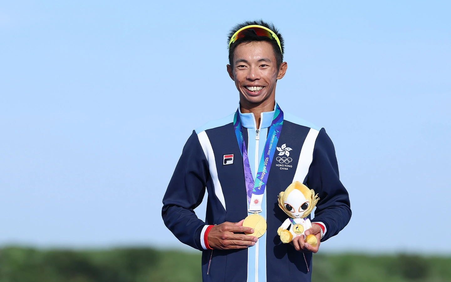 Asian Games: Hong Kong’s rowers strike gold - Gold medallist Chiu Hin-chun poses during the awarding ceremony for the men's lightweight single sculls in Kaizu, Gifu Prefecture
