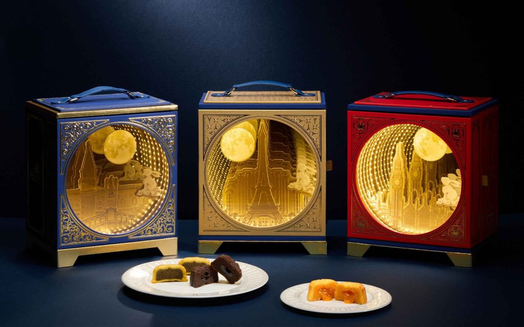 The 'Eternal Moon' boxes, each opening onto an illuminated paper-cut moonscape with rabbits mid-hop beneath the full moon
