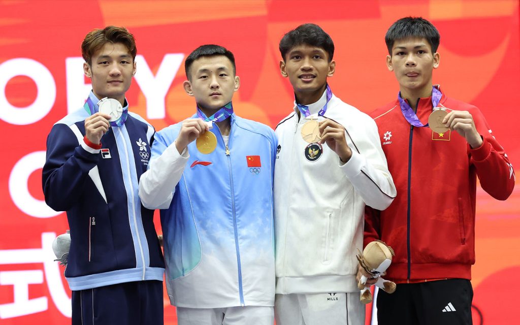 Gold medallist Tang Sishuo of China, silver medallist Leung Yu-hong of Hong Kong, and joint bronze medallists Guitara of Indonesia and a Vietnamese athlete pose after the men's 60kg sanda final in Nagoya